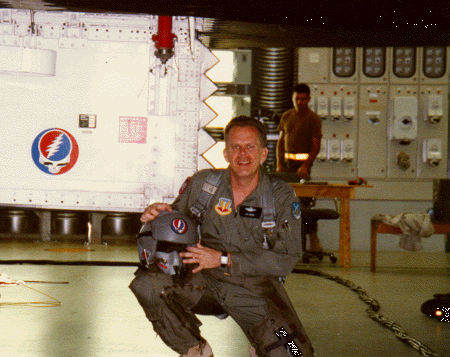 Picture of Leo in his 
flight suit, holding his helmet